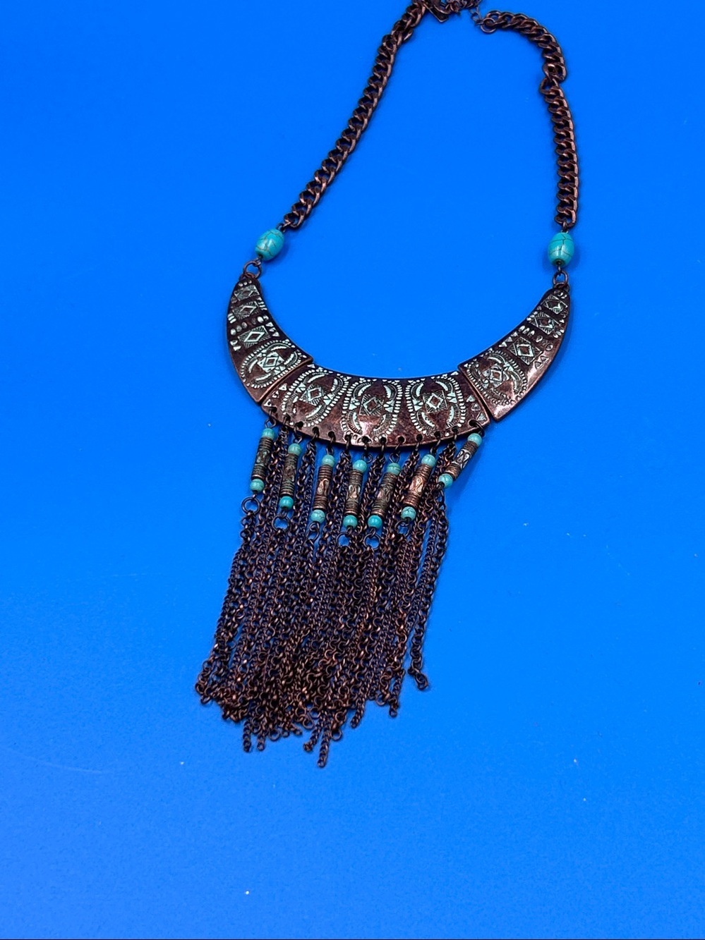 Vintage-style, copper-tone metal necklace featuring turquoise beads